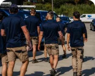Plumbers walking to their service vans on a Cabramatta job